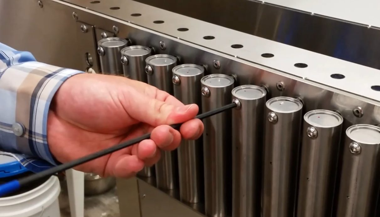 HMJ tech engineer tightening screw on the Modular Design Dispenser